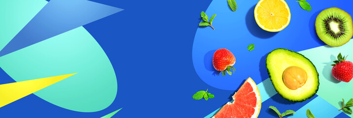 Avocado and mixed fruits overhead view flat lay