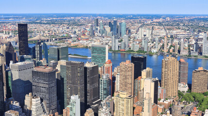 Fototapeta na wymiar Aerial of the the concrete jungle New York city with the New York habour where the Hudson river meets the Atlantic ocean, home of highrise skyscraper buildings, a display of architectural marvel 