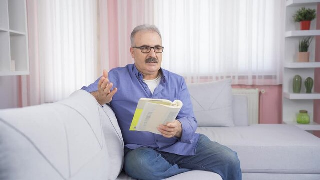 The grumpy old man gets angry at the book he's reading.