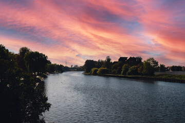 Stunningly beautiful lake in the golden autumn season. Magical multi-color reflection with light ripples on the surface of the water fall evening. Autumn scenery Colorful vibrant autumn forest with