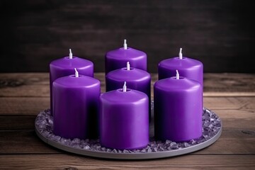 Obraz na płótnie Canvas group of lavender candles arranged on a decorative plate