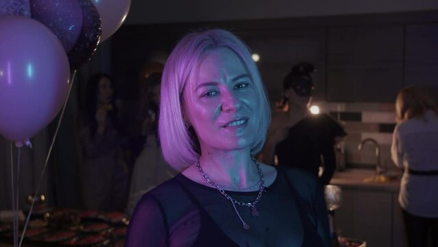 Portrait of woman in party posing with tickler