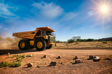 Fototapeta huge yellow mining truck on a dirt road obraz