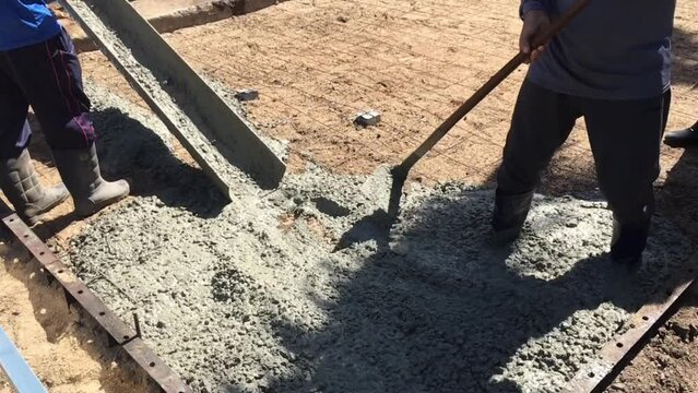 Mixing together to make a strong concrete floor, Mixing concrete concept, Slow motion