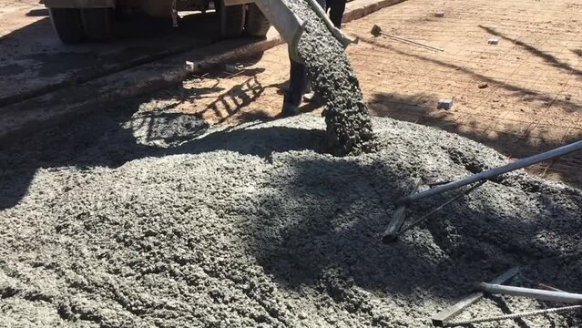 Mixing together to make a strong concrete floor, Mixing concrete concept, Slow motion