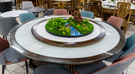 Fototapeta premium Chinese dining table, a round dining table with plant scenery.