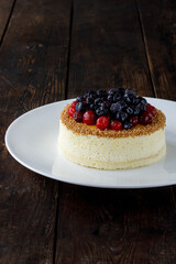 Delicious cake on plate on brown wooden table 