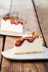 Delicious cake on plate on brown wooden table 