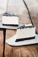 Delicious cake on plate on brown wooden table 