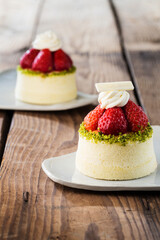 Delicious cake on plate on brown wooden table 