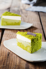 Delicious cake on plate on brown wooden table 