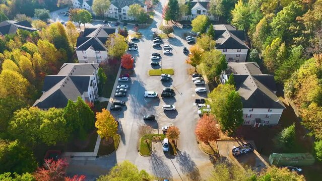 View from above of apartment residential condos between yellow fall trees in suburban area in South Carolina. American homes as example of real estate development in US suburbs