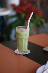 Closeup of Iced Caramel Macchiato at the coffee shop, Caramel Macchiato is a classic macchiato beverage. It consists of vanilla syrup, espresso, steamed milk, foam, and caramel drizzle