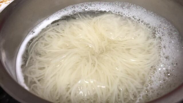 Korean traditional noodles are boiling before the dish is done