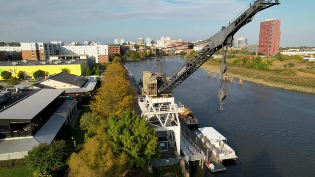 cinematic drone push on Wilmington Delaware riverfront with iconic historic crane dramatic flyover