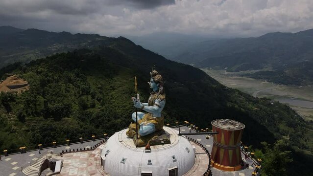 Aerial view of the statue of Lord Shiva in Nepal. Drone flight with a view of the Mahadev Monument in Pokhara. Cinematic 4k footage.