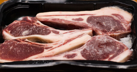 Beef tenderloin is packaged in a black pack for sale in a department store.