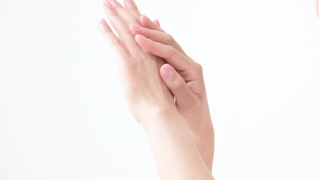 Slow motion picture of two hands together applying cream and moisturizer no-face