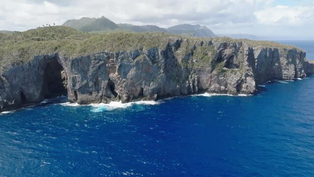 Aerial wide shot of Nationalpark Cabo Cabr&oacute;n with rocky coastline and blue Caribbean Sea during cloudy day