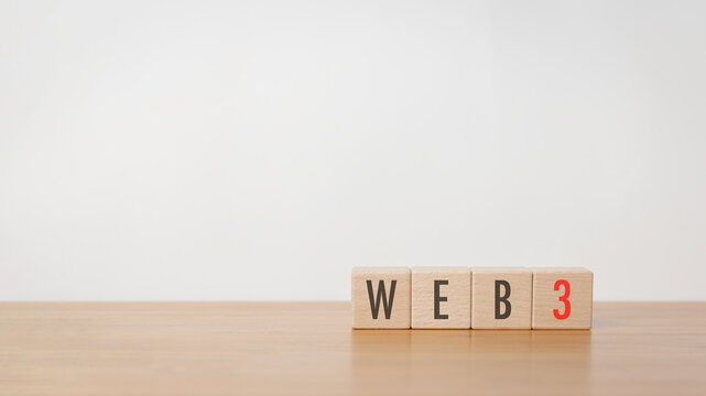 Wood cube block with web3 put on wooden table in white background. Web 3.0 technology, decentralized, AI Chat bot, digital security and encryption concept.
