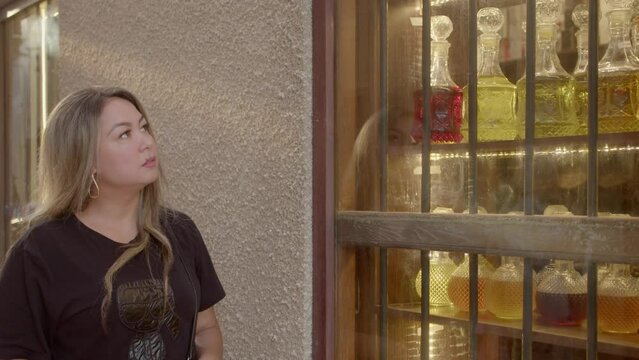 18th-century Al Fahidi Fort. Woman looking through a shop glass