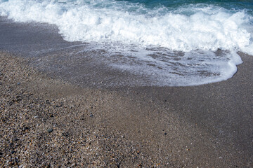 Sea waves run on the shore of the sea or ocean. Beautiful relaxing view on vacation.