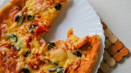 Cut off a piece of pizza.Homemade pizza on a plate. 