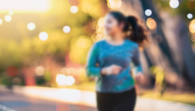 Defocused bokeh effect positive concept background of unrecognizable people enjoying healthy lifstyle exercising fitness outside