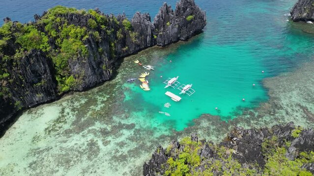 Dugout outrigger bangka canoes in shallow sandbar of palawan philippines