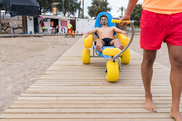 lifeguard dragging an injured man with chair on the beach