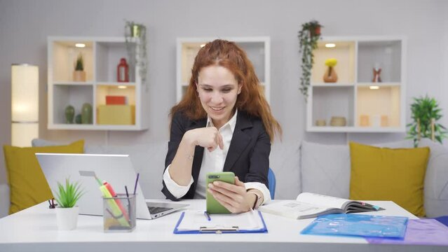 Home office worker woman talking on the phone facetime happily.
