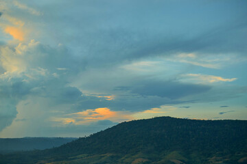 Sunset amidst clouds over the mountains
