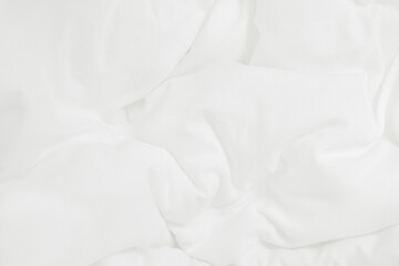 Close up top view of white bedding sheet and wrinkle messy blanket in bedroom after wake up in the...