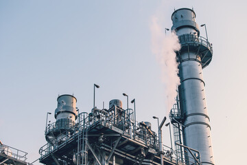 Power station clean modern factory Petroleum petrochemical industry building outdoors landscape with large chimney releasing smoke. - obrazy, fototapety, plakaty