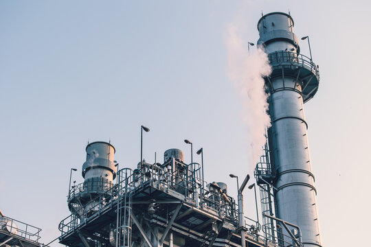 Power station clean modern factory Petroleum petrochemical industry building outdoors landscape with large chimney releasing smoke.