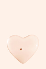 round drops of transparent gel serum on beige background