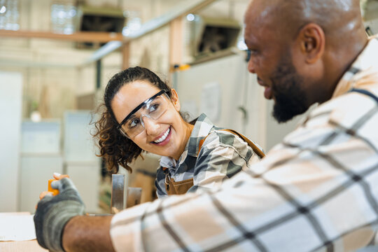 happy woman builder worker cute smile talking relationship with worker friend enjoy working together. workshop partner lovely staff employee.