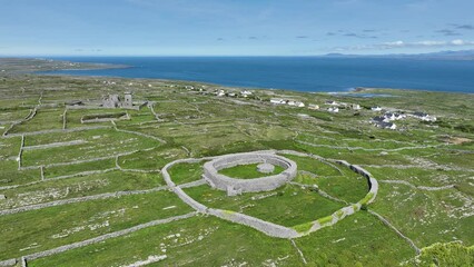 Drone circling prehistoric fort on inis Mor Aran Islands West Of Ireland with stunning vistas of the island and Atlantic Sea