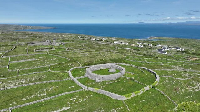 Drone circling prehistoric fort on inis Mor Aran Islands West Of Ireland with stunning vistas of the island and Atlantic Sea