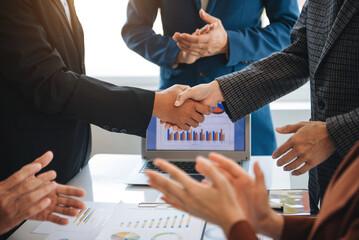 business people shaking hands during a meeting in modern office