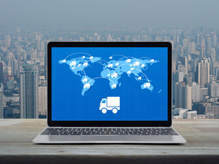 Delivery truck icon with connection line and world map on modern laptop computer screen on table over city tower, Business transportation online, Elements of this image furnished by NASA