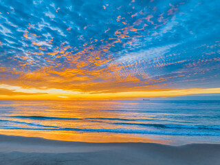 Naklejka na ściany i meble Sunrise at the seaside with beautiful cloudcover
