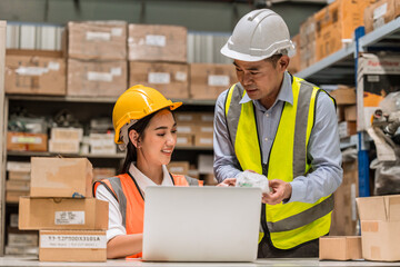 senior engineer manager supervisor working with young woman engineer staff worker in factory hardware parts store inventory room
