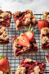 Strawberry granola bars on baking cooling rack . Delisious homemade oat squares for breakfast