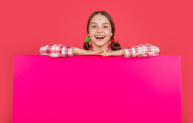 happy child with blank pink paper with copy space for advertisement