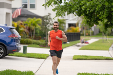 The running man enjoys the freedom of running outdoor. The running man feels sense of joy during the run. sport fit man jogging outdoor. The running man races down the neighbourhood. Stay active