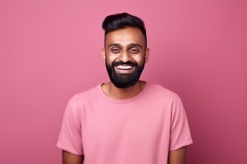 Handsome Indian guy laughing on pink background. Generative AI