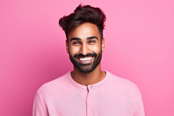 Obraz premium Handsome Indian guy laughing on pink background. Generative AI