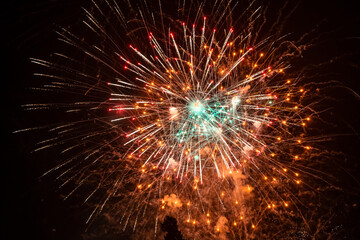 Beautiful festive fireworks on the dark sky.