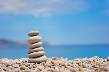 Stack of pebble stones with sea on the background